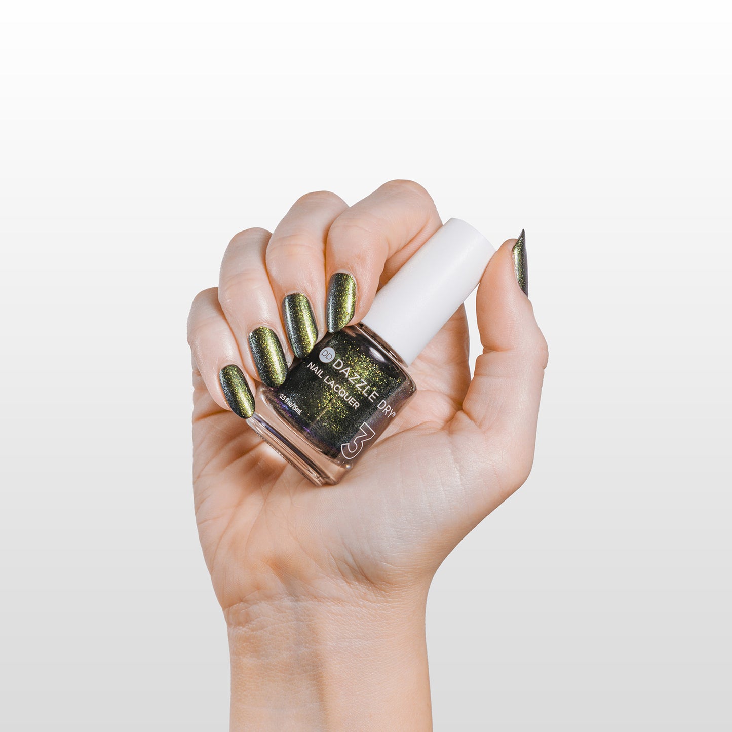 Hand with Dragonfly painted on nails holding lacquer bottle