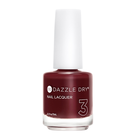 A bottle of Dazzle Dry Nail Lacquer in shade 3, featuring a deep burgundy red color inside a clear glass bottle with a white cap, set against a plain white background.