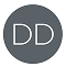 Dazzle Dry ‘DD’ logo on grey background with white lettering and white circle.