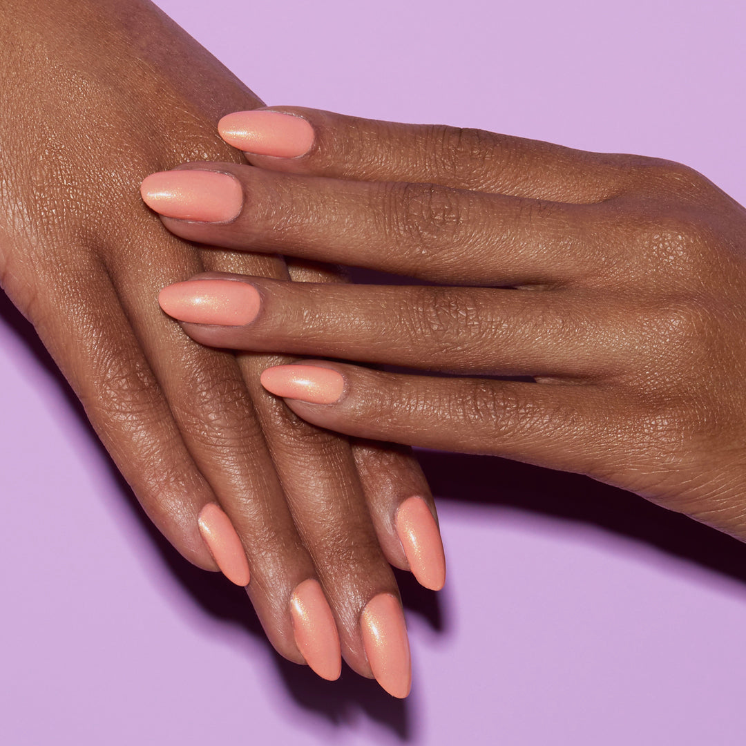 Hands with Sunset Glow painted on nails