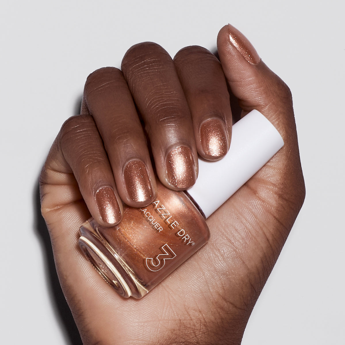 Hand with Raise Your Glass painted on nails holding nail lacquer bottle