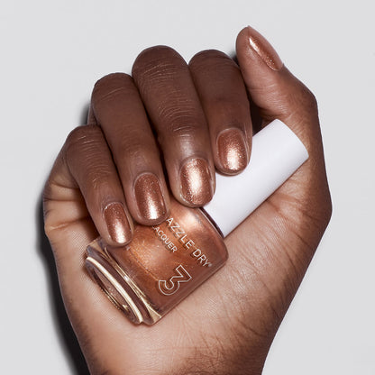 Hand with Raise Your Glass painted on nails holding nail lacquer bottle