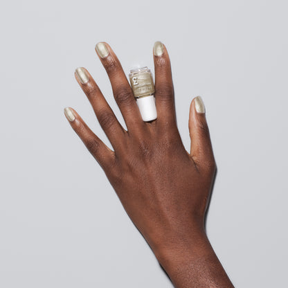 Hand with Illuminate painted on nails holding mini nail lacquer bottle