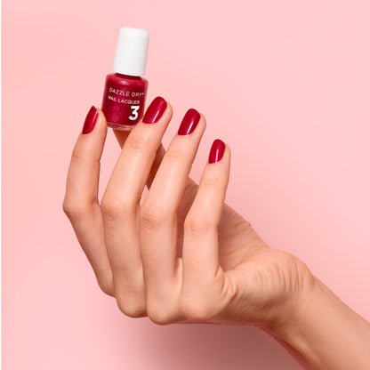 Hand with Apple Of My Eye painted on nails holding mini lacquer bottle