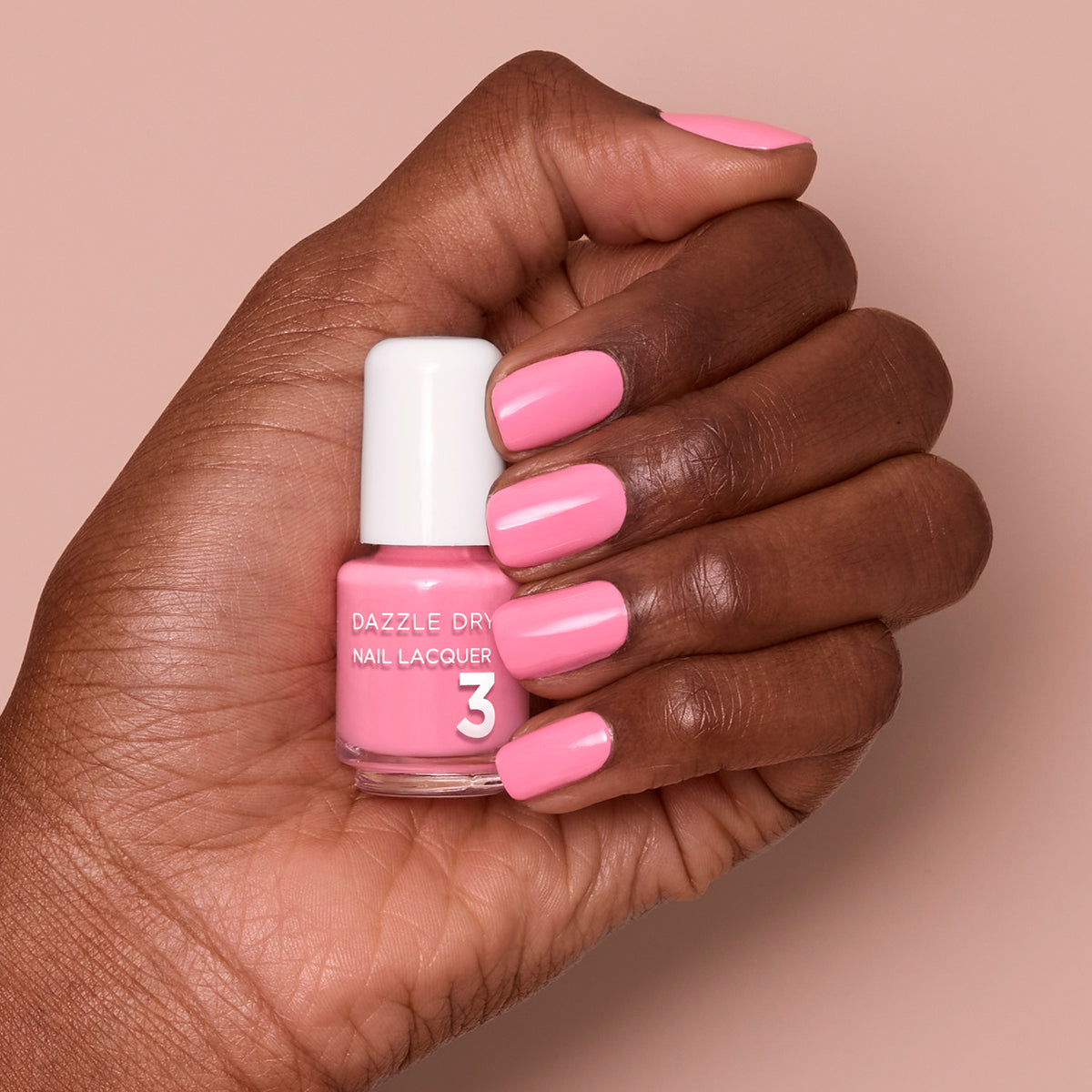 Hand with Soulmate painted on nails holding mini lacquer bottle