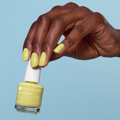 Hand with Fresh Squeezed painted on nails holding lacquer bottle