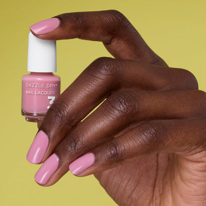 Hand with Picking Peonies painted on nails holding mini lacquer bottle