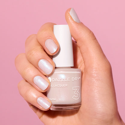 Hand with Artisan painted on nails holding lacquer bottle