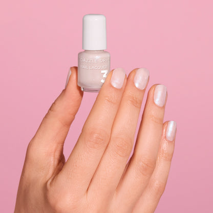 Hand with Artisan painted on nails holding mini lacquer bottle