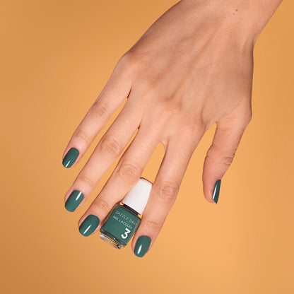 Hand with 3-Day Weekend painted on nails holding mini lacquer bottle