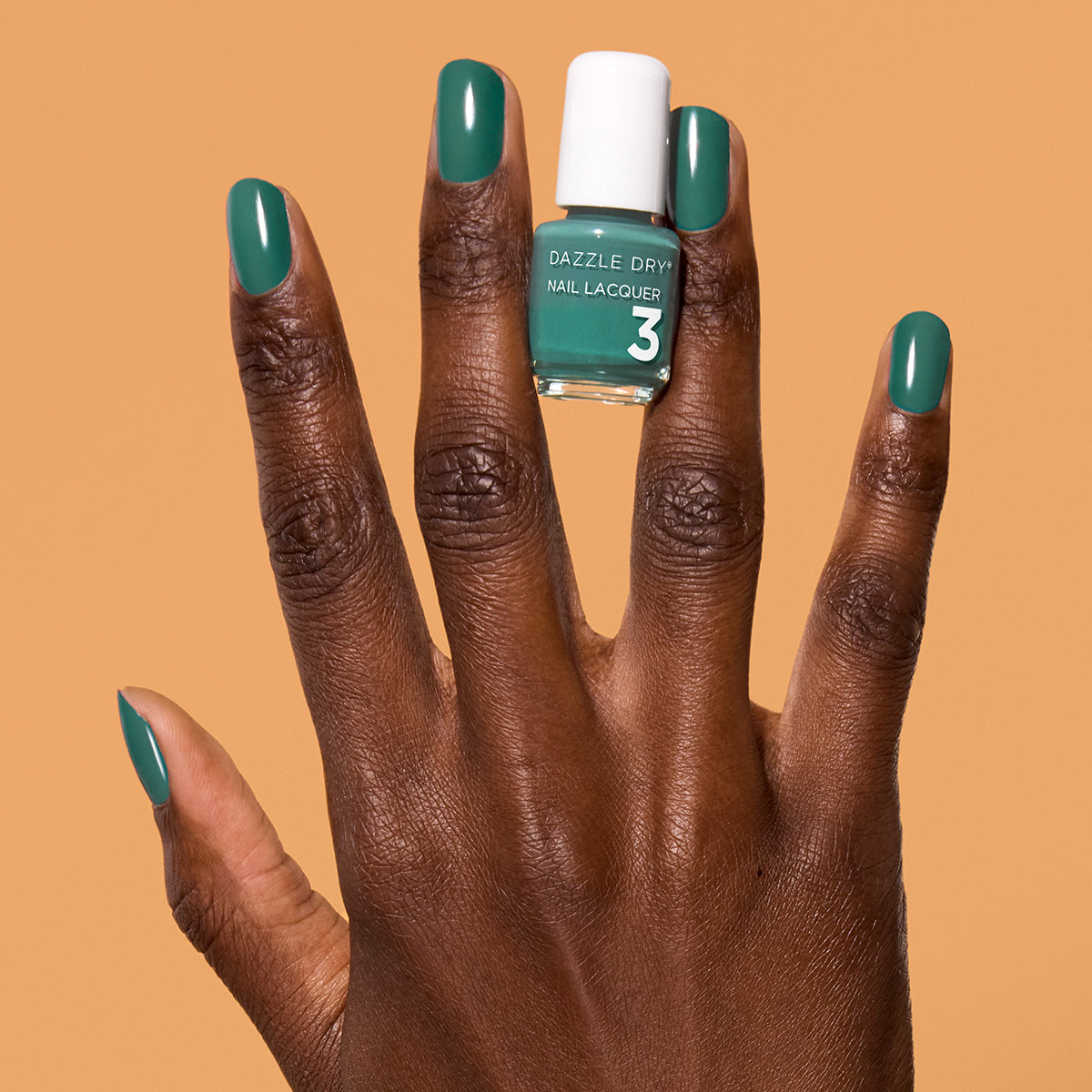 Hand with 3-Day Weekend painted on nails holding mini lacquer bottle