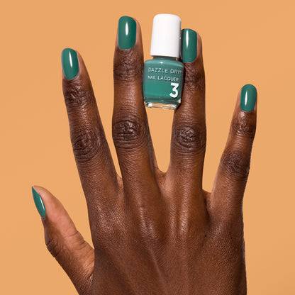 Hand with 3-Day Weekend painted on nails holding mini lacquer bottle