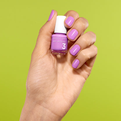 Hand with In The Moment Painted on nails holding mini lacquer bottle