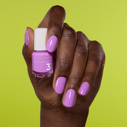 Hand with In The Moment Painted on nails holding mini lacquer bottle