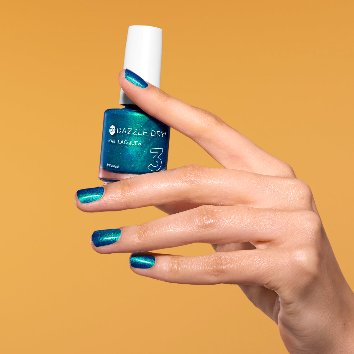 Hand with Speed Boat painted on nails holding lacquer bottle