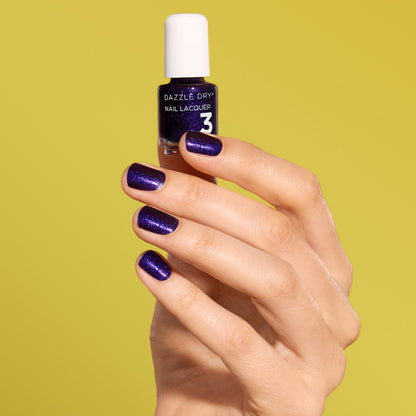 Hand with Fast Lane painted on nails holding mini lacquer bottle