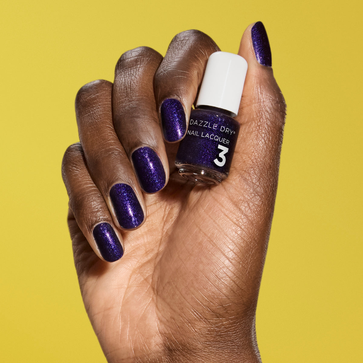 Hand with Fast Lane painted on nails holding mini lacquer bottle