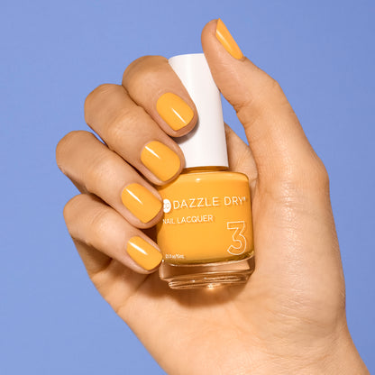 Hand with Go Go Mango painted on nails holding full size lacquer bottle