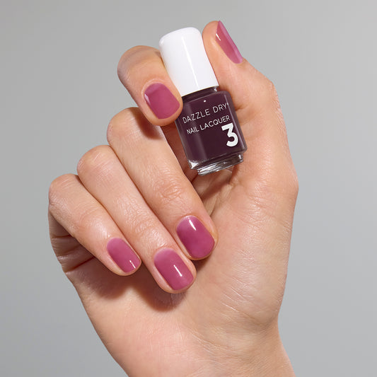 Hand with Tickets Please painted on nails holding mini lacquer bottle