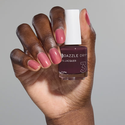 Hand with Tickets Please painted on nails holding full size lacquer bottle