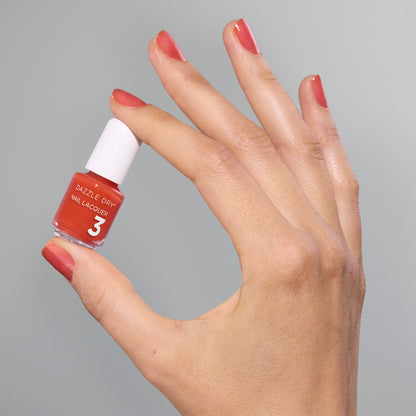 Hand with Sweet and Juicy painted on nails holding mini size lacquer bottle