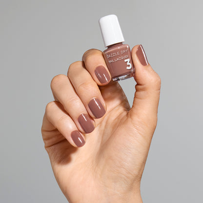 Hand with Your Nails, But Better painted on nails holding mini lacquer bottle