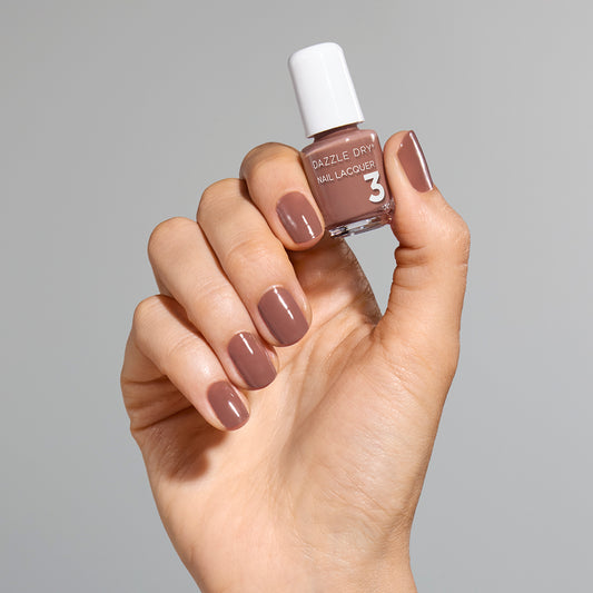 Hand with Your Nails, But Better painted on nails holding mini lacquer bottle