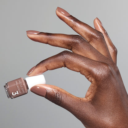 Hand with Your Nails, But Better painted on nails holding mini lacquer bottle