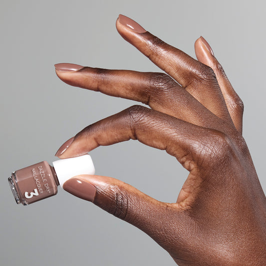 Hand with Your Nails, But Better painted on nails holding mini lacquer bottle