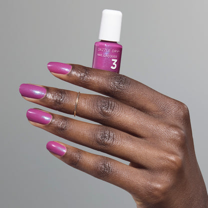 Hand with Mulberry painted on nails holding mini lacquer bottle