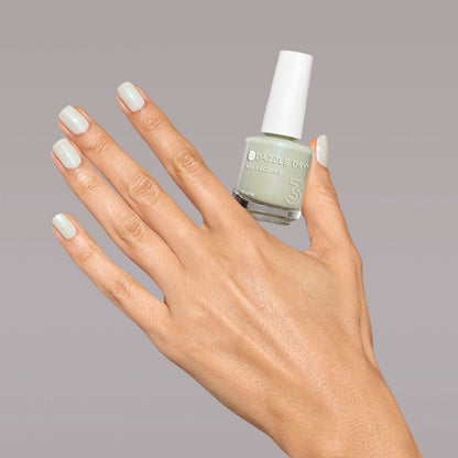 Hand with Embark painted on nails holding full size lacquer bottle