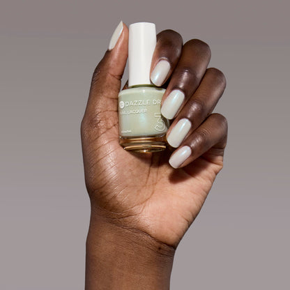 Hand with Embark painted on nails holding full size lacquer bottle