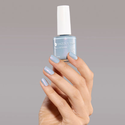 Hand with Ski Lift painted on nails holding full size nail lacquer