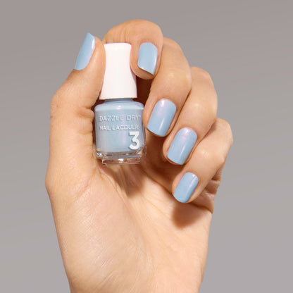 Hand with Ski Lift painted on nails holding mini nail lacquer