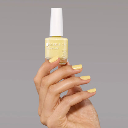 Hand with Solstice painted on nails holding full size lacquer bottle