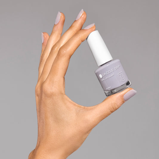 Hand with Fresh Start painted on nails holding lacquer bottle