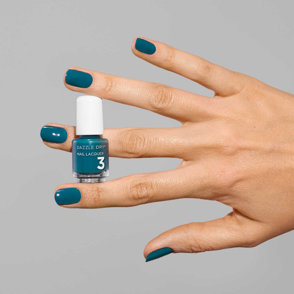 Hand with My Serenity painted on fingernails holding mini nail polish bottle