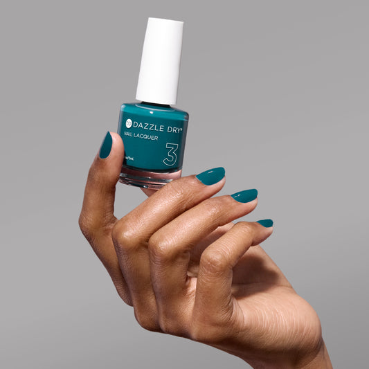 Hand with My Serenity painted on nails holding lacquer bottle