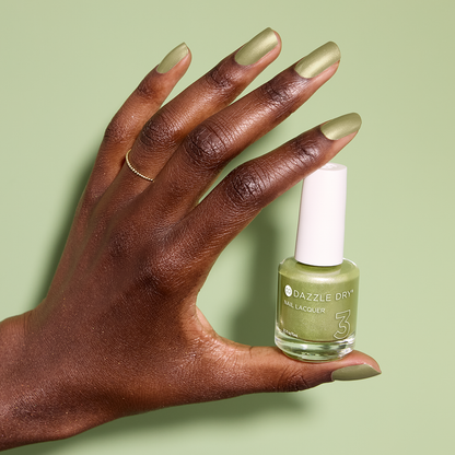 Hand with Lucky Me painted on nails holding lacquer bottle