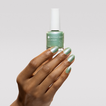 Hand with Aurora painted on nails holding lacquer bottle