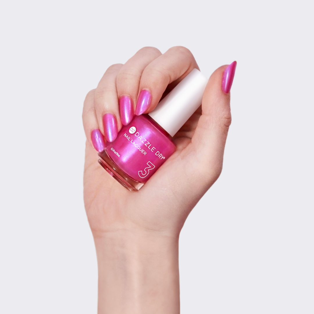 Hand with Beloved painted on nails holding lacquer bottle