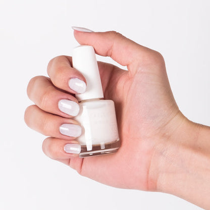 Hand with Breathe Free painted on nails holding lacquer bottle