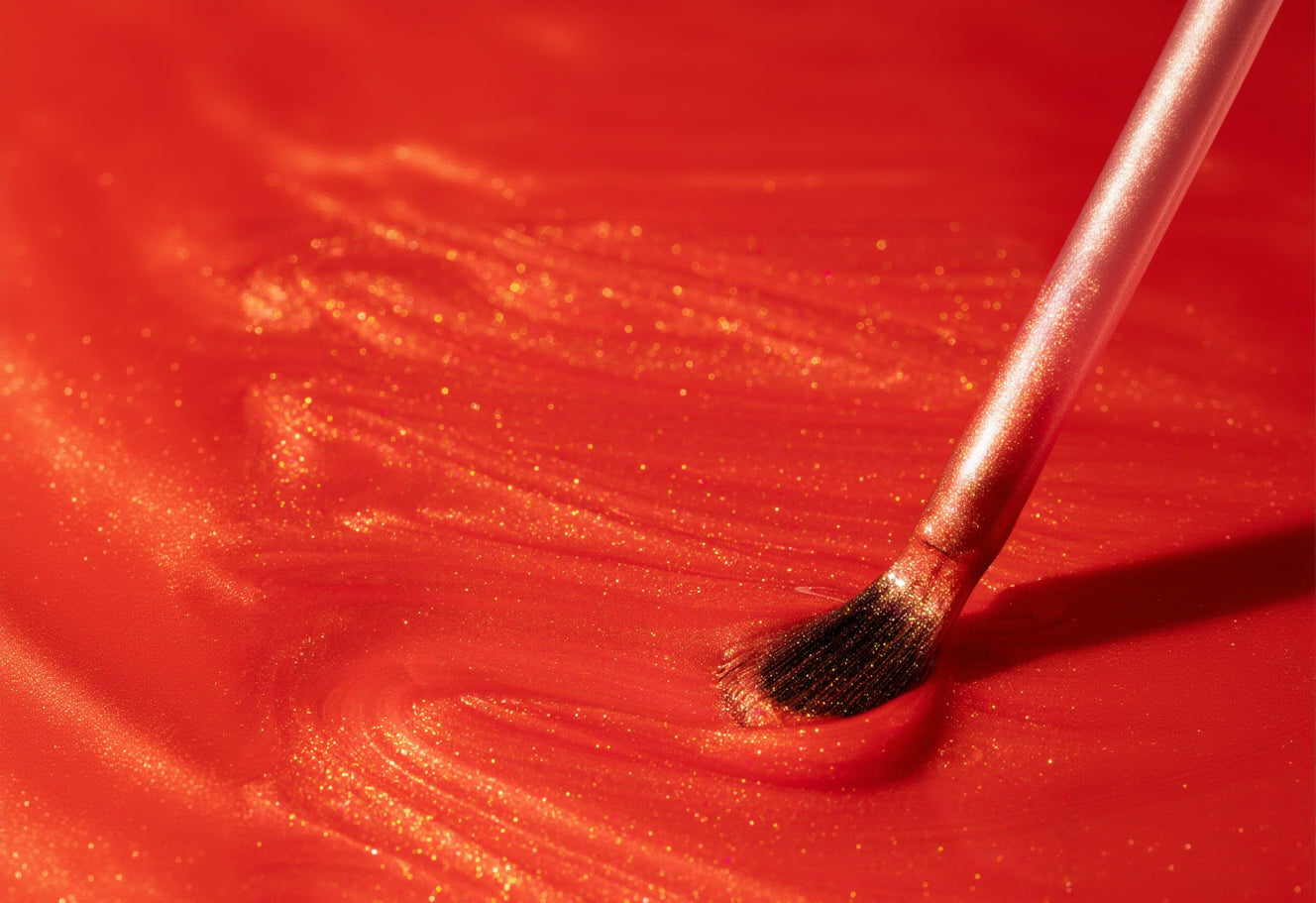 Makeup brush on a red surface with glitter