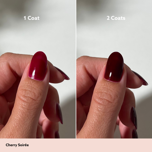 A split-screen comparison showing a fingernail polish swatch labeled '1 Coat' on the left and '2 Coats' on the right, with the shade name 'Cherry Soirée' at the bottom. The polish appears as a deep cherry red on one side and a darker, near-black cherry red on the other.