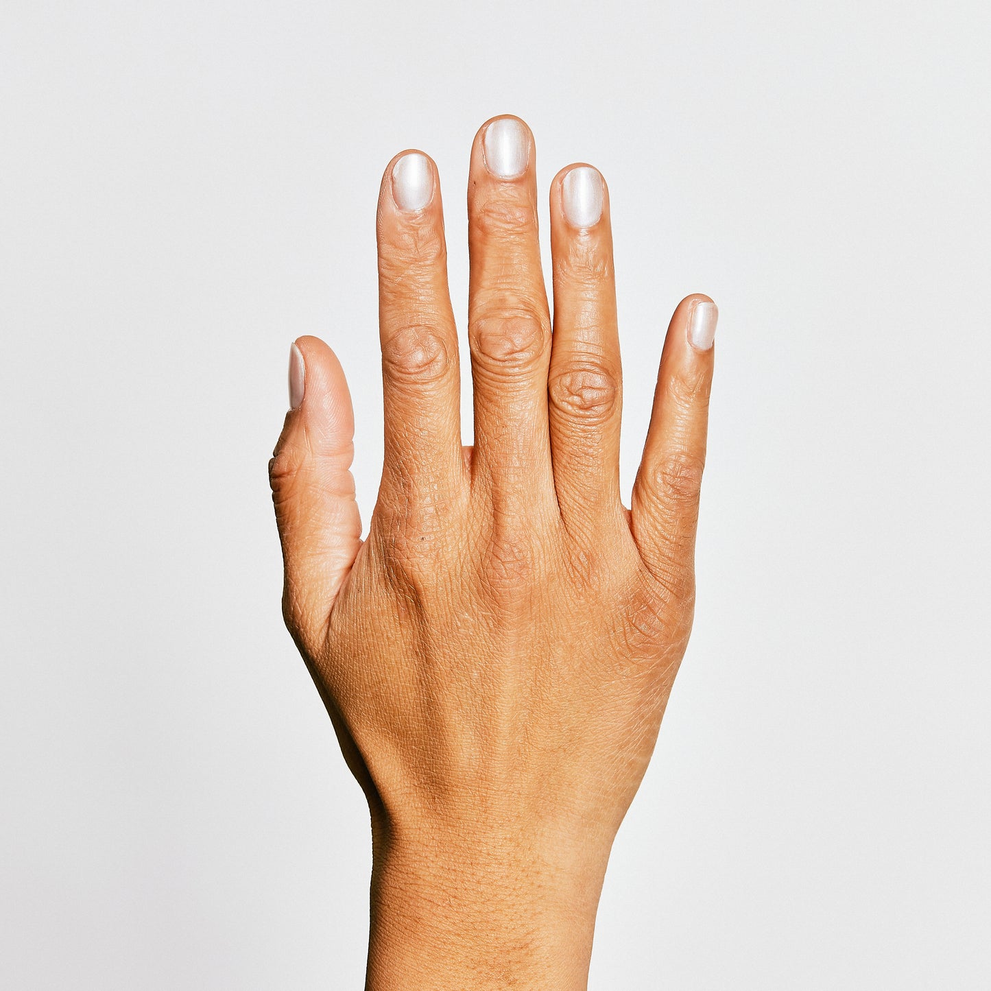 Hand with Pearl painted on nails