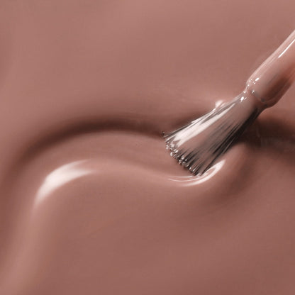 A close-up of a glossy mauve-pink liquid swatch with a brush stroke applying the color.