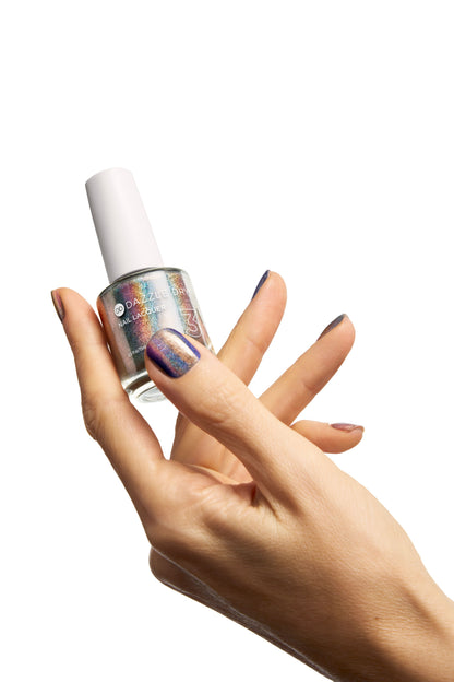 A hand holding a bottle of Multichrome nail polish, showcasing the iridescent holographic polish on the fingernails against a solid white background.