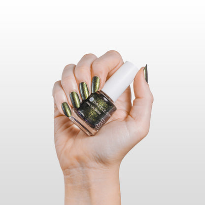 Hand with Dragonfly painted on nails holding lacquer bottle