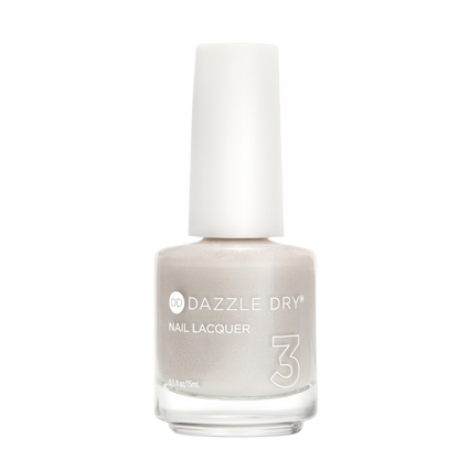 A bottle of Dazzle Dry Nail Lacquer in shade 3, featuring a shimmering light champagne-beige color and a white cap, set against a plain white background.