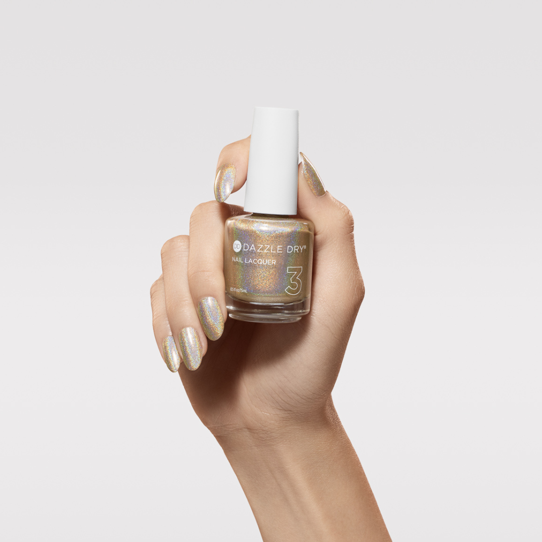 Hand with Light-Year painted on nails holding lacquer bottle
